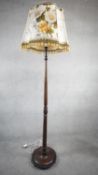 A vintage mahogany standard lamp on platform base. H.181