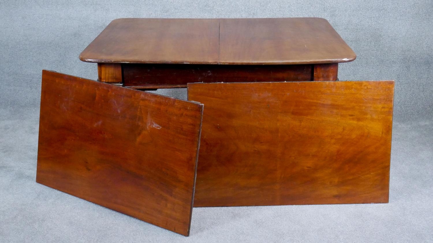 A mid Victorian mahogany extending dining table, the moulded rounded rectangular top with two - Image 2 of 6