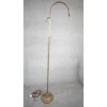 A vintage solid brass height adjustable arched design standard lamp with weighted circular base