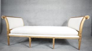 A Louis XVI giltwood daybed in the style of JEAN-BAPTISTE SENE. With fitted cushion, carved and