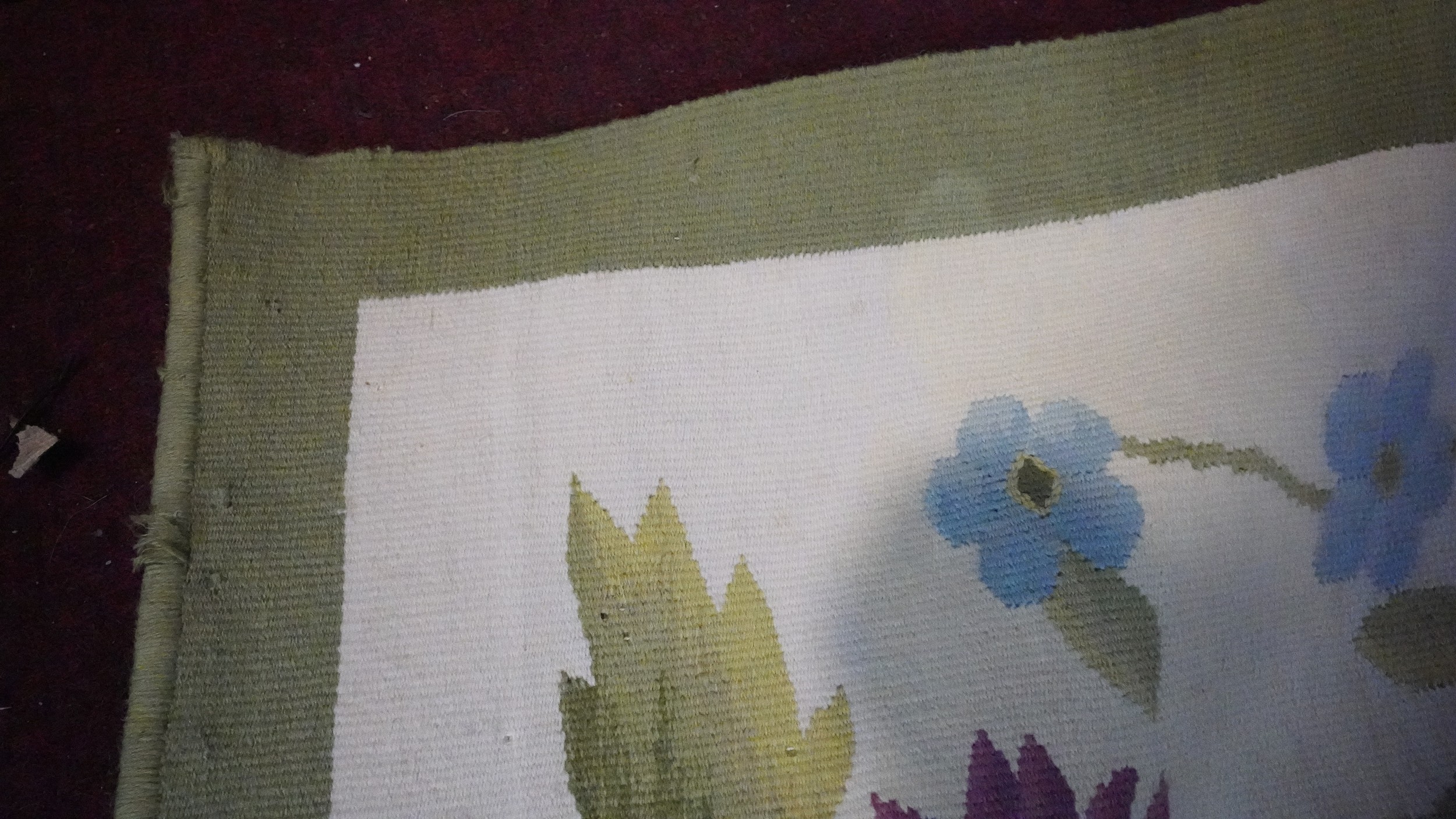 A needlepoint carpet on a cream ground within a floral border. H.258 W.256 - Image 5 of 7