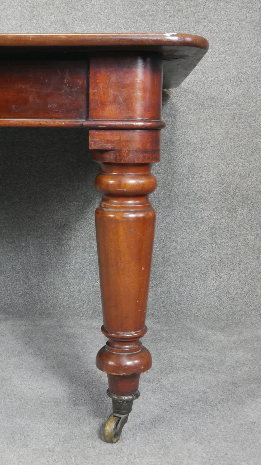 A mid Victorian mahogany extending dining table, the moulded rounded rectangular top with two - Image 5 of 6