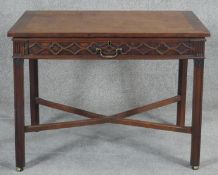 A Georgian mahogany side table with fret carved drawer on square cross stretchered supports