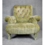 A contemporary Victorian style roll arm easy chair in deep, purple floral buttoned upholstery on