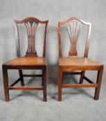 Two Georgian country oak pierced splat back dining chairs with solid seats on square stretchered