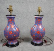 A pair of vintage hand painted ceramic Chinese vase design table lamps, stylised red flowers on a