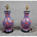 A pair of vintage hand painted ceramic Chinese vase design table lamps, stylised red flowers on a