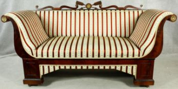 A 19th century Continental mahogany and ebonised framed sofa with carved back rail and ormolu