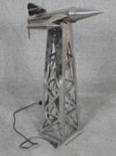 A vintage chrome metal rocket lamp on launch column, pierced geometric design. H.70cm