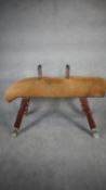 An early 20th century Niels Larsen pommel horse with adjustable legs and handles in suede with