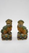 A pair of Sancai Kangxi style late Qing ceramic Foo dogs with green and yellow glaze. Unmarked. H.19