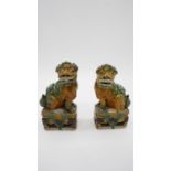 A pair of Sancai Kangxi style late Qing ceramic Foo dogs with green and yellow glaze. Unmarked. H.19