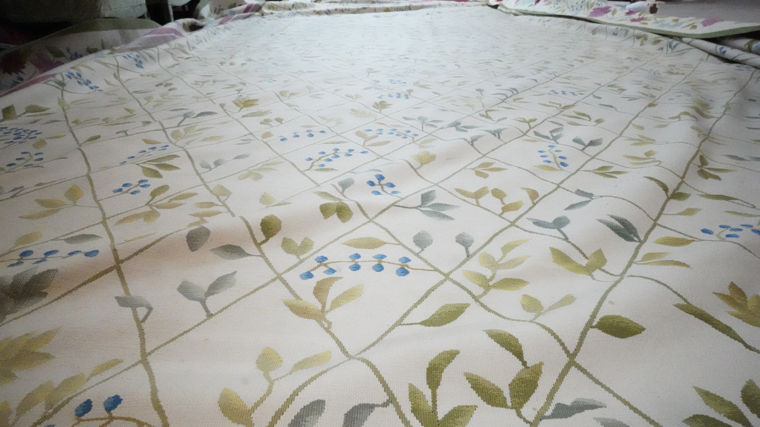 A needlepoint carpet on a cream ground within a floral border. H.258 W.256