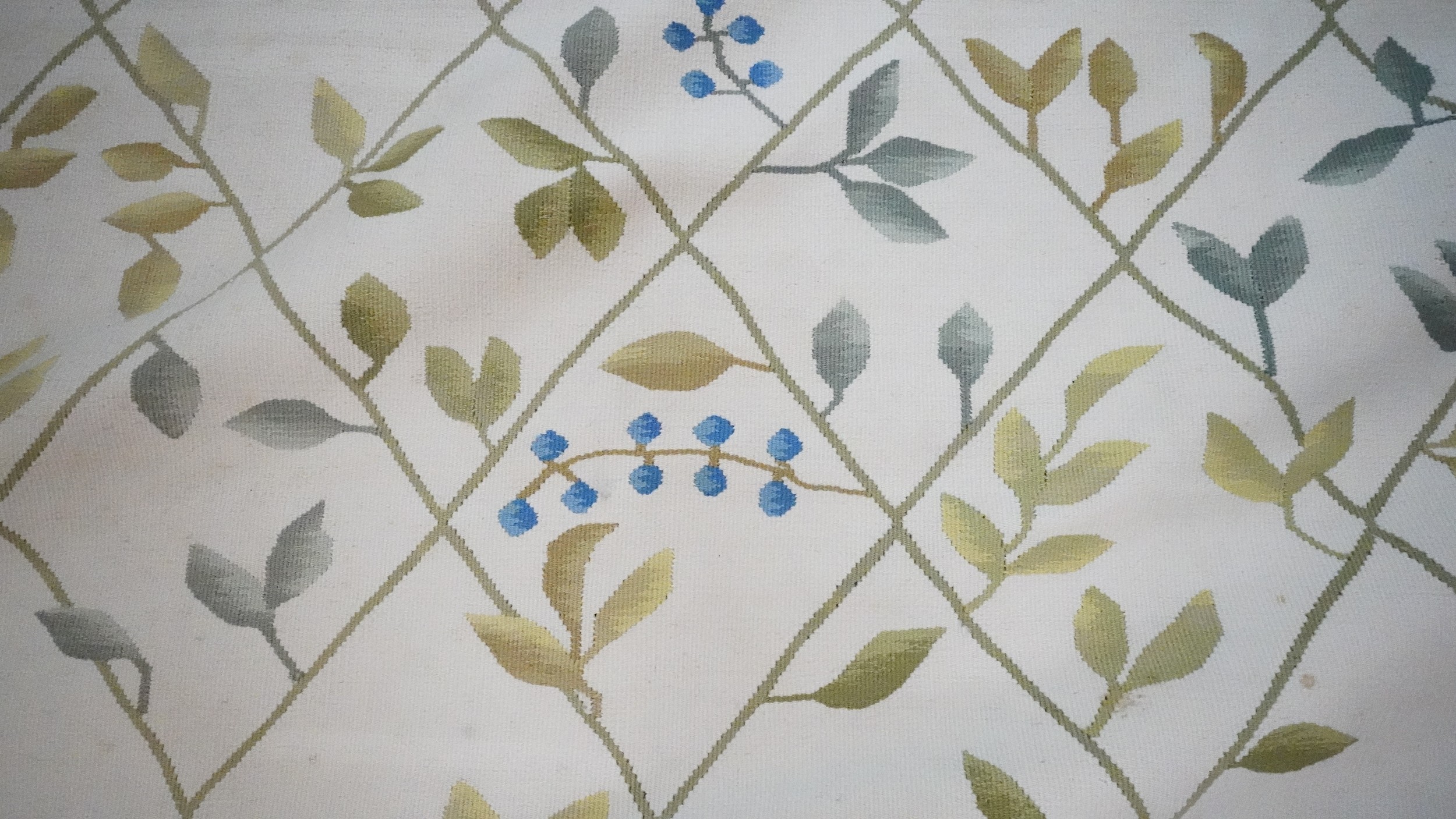 A needlepoint carpet on a cream ground within a floral border. H.258 W.256 - Image 3 of 7