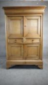 A late 19th century French Provincial oak pantry cabinet with frieze drawer above panel doors and