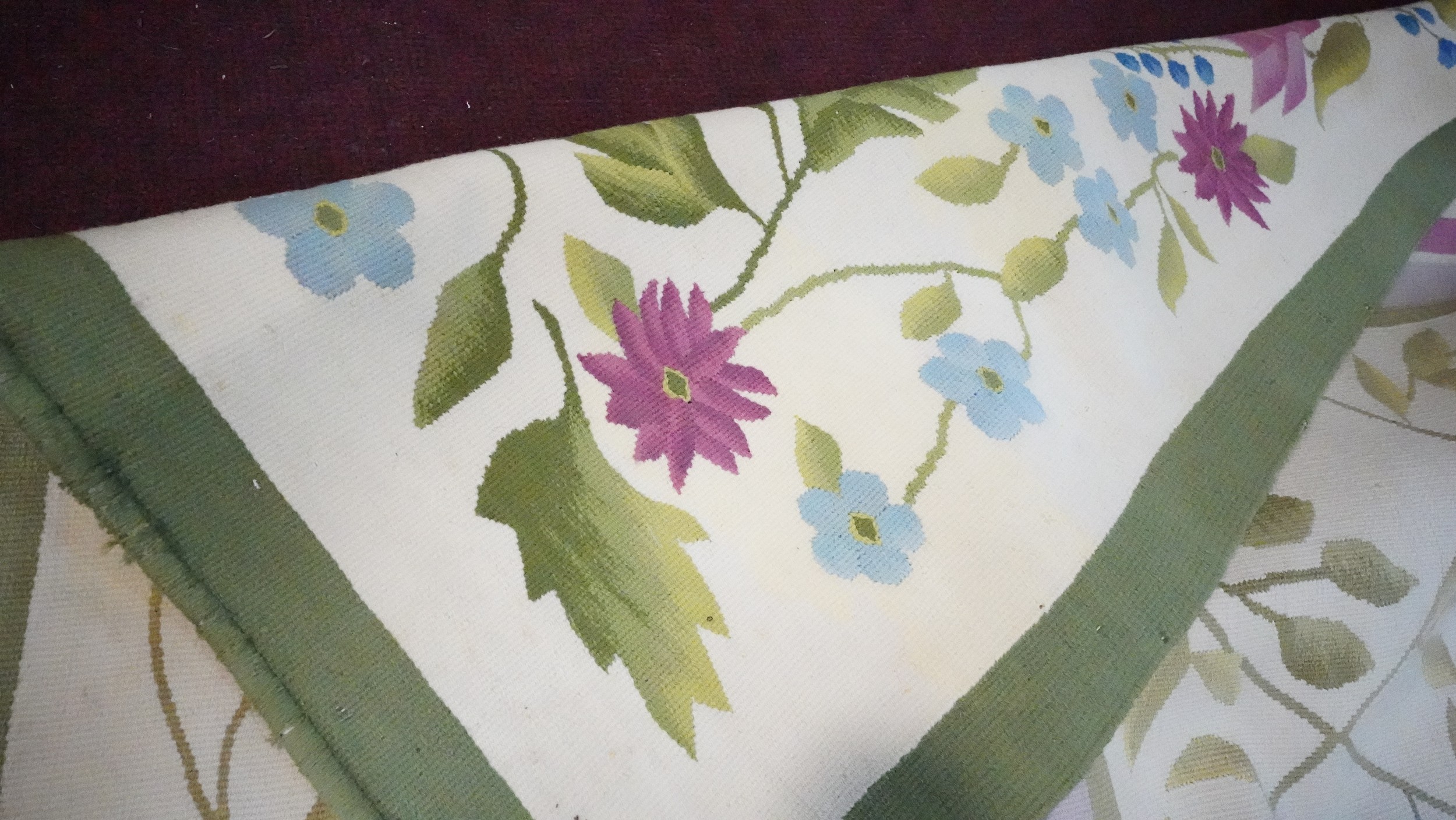 A needlepoint carpet on a cream ground within a floral border. H.258 W.256 - Image 6 of 7