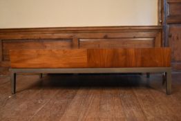 A contemporary teak coffee table fitted with end drawer on metal base with square tapering supports.