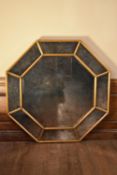 A large contemporary octagonal gilt framed wall mirror with faux aged glass plate. H.120 W.120cm