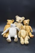 A collection of five teddy bears, four antique one made by Merrythought, with label on the foot. H.