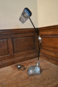 An Art Deco chrome anglepoise desk lamp on stepped base marked: Flexo. H.100 W.46 D.23cm