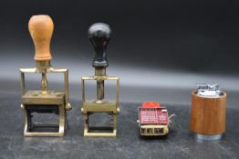 Two vintage brass date stamps, a mailing stamp and a vintage table top lighter. H.20 W.9cm (
