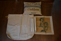A cushion, canvas sacks and three Chanel posters. H.47 W.60cm (2)
