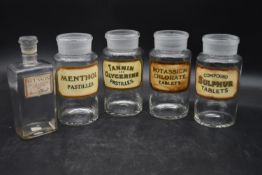 A matching set of four vintage pharmacy tablet jars with stoppers along with a vintage French