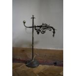 A vintage adjustable wrought iron desk lamp with scrolling foliate detail. H.67 W.30cm