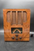 A 1930's PYE radio in figured walnut case. (In working order). H.45 W.35 D.26cm