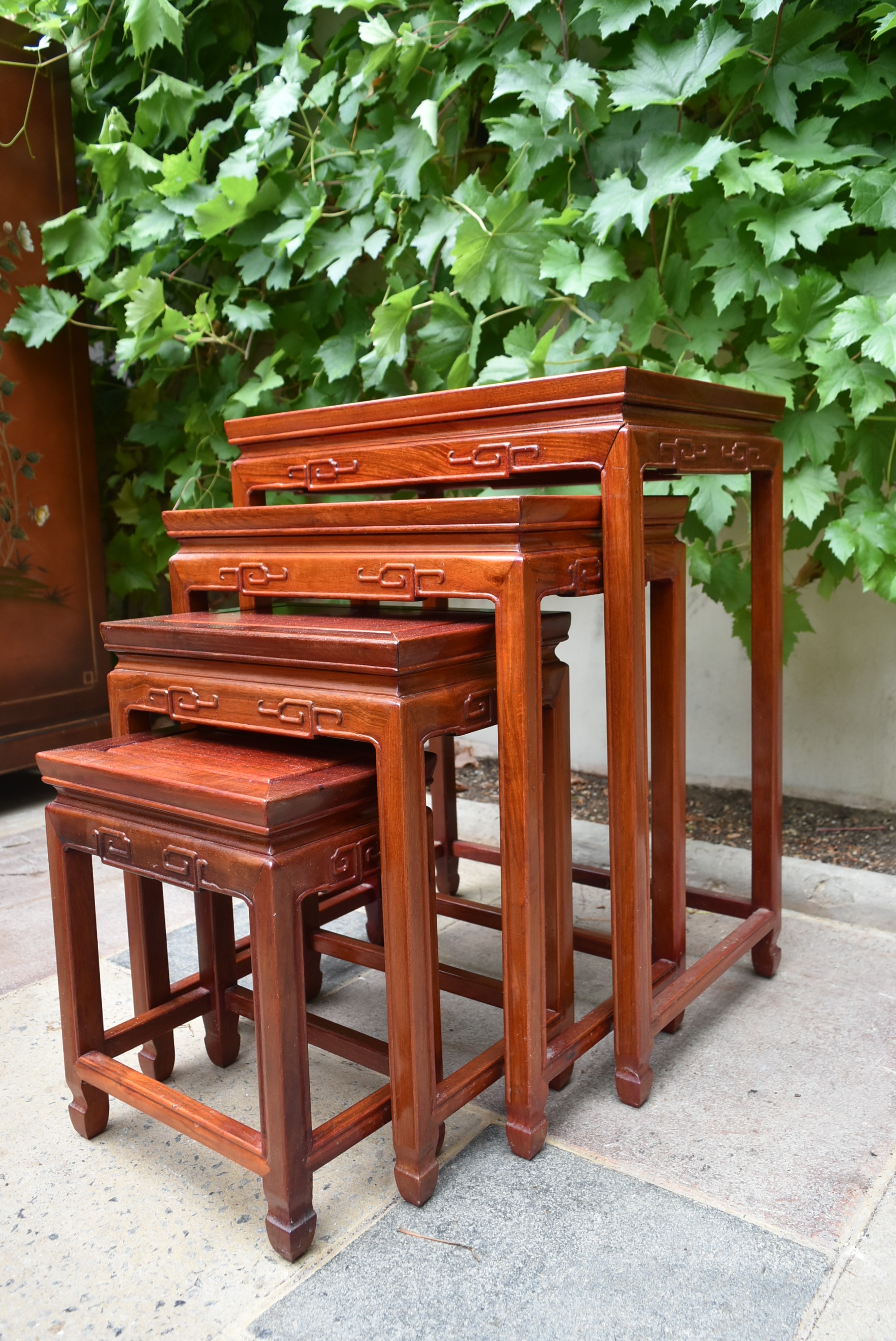 A nest of four Chinese hardwood graduating occasional tables with carved friezes on square - Image 2 of 4