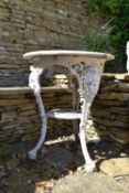 A Coalbrookedale style cast iron garden table on tripod mask supports. H.72 W.61cm