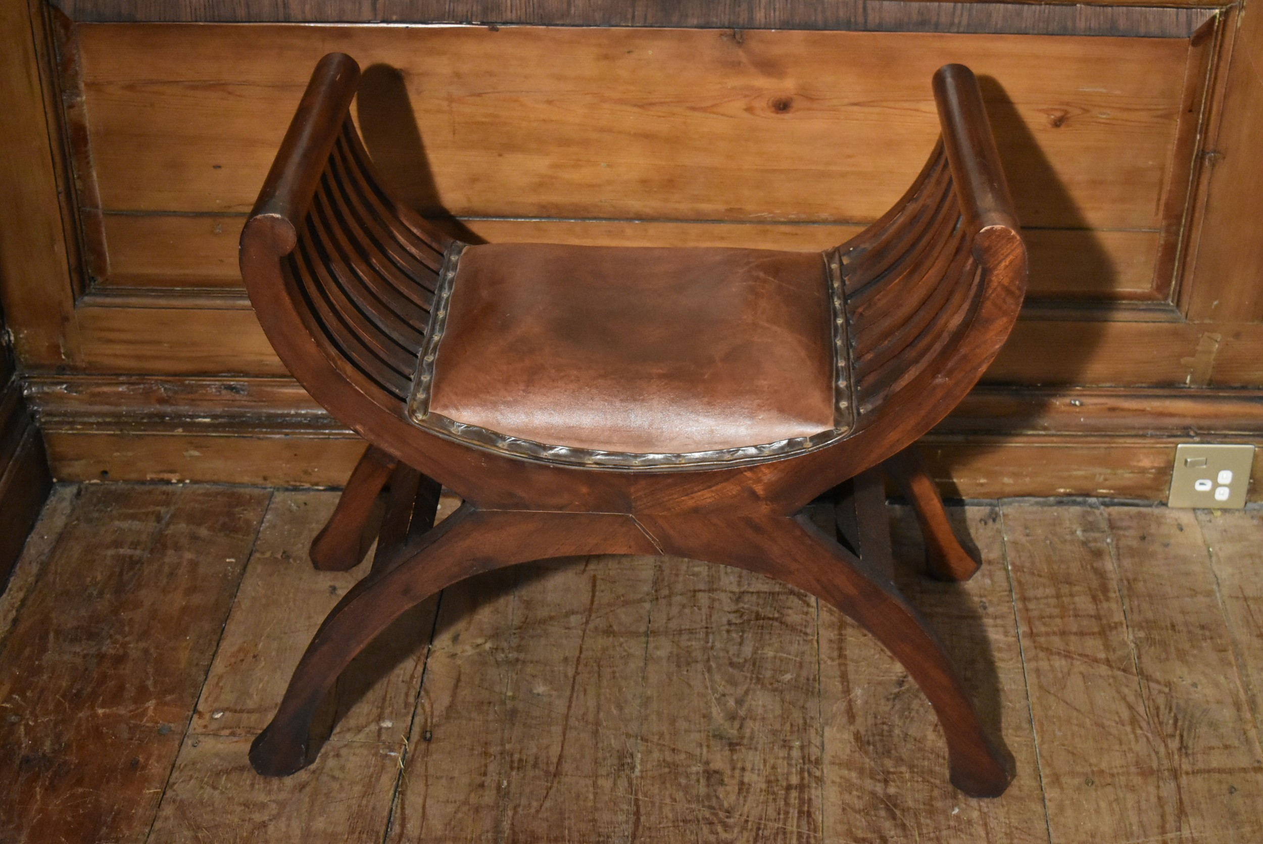 A contemporary teak X framed stool in leather upholstery. H.60 W.56 D.37cm - Image 2 of 5