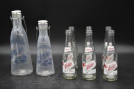 Two vintage milk bottles with stoppers marked; Le bon lait along with six vintage Oscar's