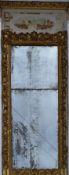 A 19th century carved giltwood and gesso full height pier mirror with painted architectural pediment