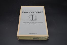 A Dawson Denim apron, unused with tags and in original box. H.31 W.22cm (box) L.99 W.74cm (apron)