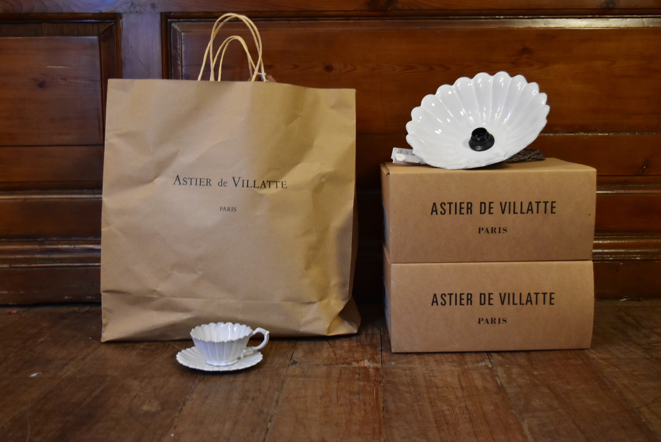 A set of five Astier de Villatte cups and saucers along with a pair of similar pendant light shades.