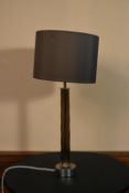 A contemporary chrome table lamp with twisted column and matching shade. H.63 W.29cm