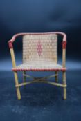 A vintage miniature wicker and cane tub shaped conservatory armchair. H.30 W.22cm