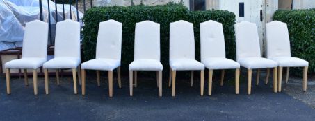 A set of eight high back calico upholstered dining chairs with fitted floral damask loose covers.