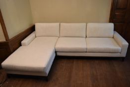 A contemporary corner sofa in cream calico upholstery on square supports. W.190 D.96cm