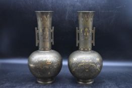 A pair of Meiji period Japanese Damascene bronze vases, decorated with dragon and pheonix design