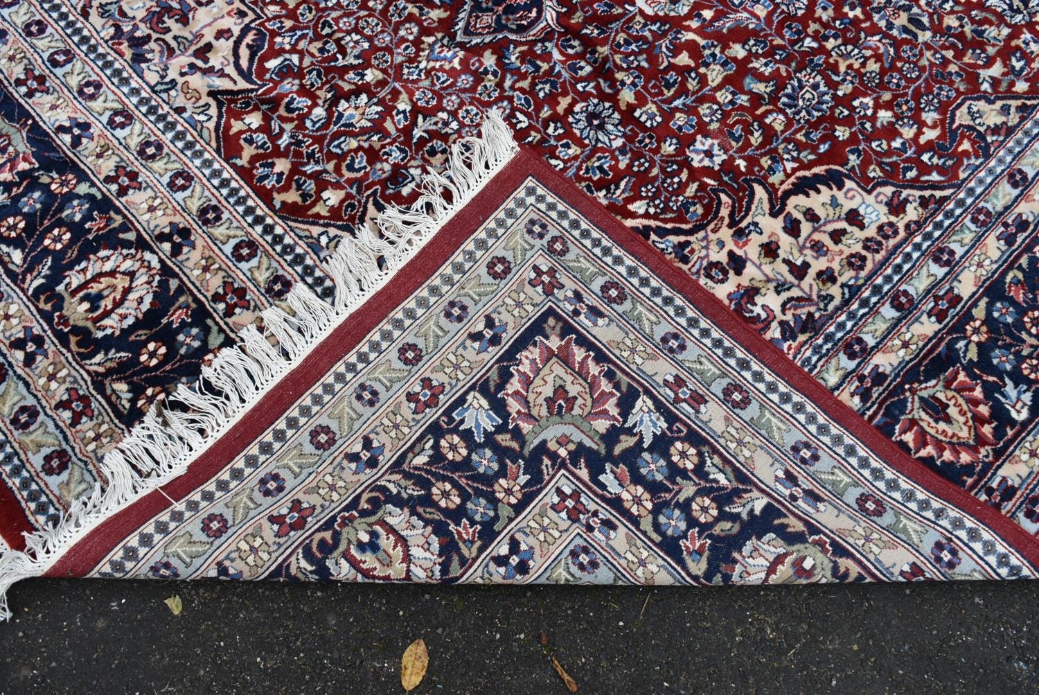 A Persian Keshan carpet with floral central medallion on burgundy ground within foliate spandrels - Image 3 of 3