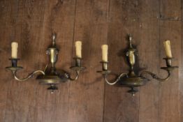 A pair of vintage brass twin branch wall sconces with scrolling arms and rams head decoration. H.