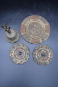 A collection of Indian brass wall plates with repousse floral design, marked 'K.B India 1227/8'.