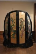 A shaped three fold, four panelled Chinese screen with glazed gilt panels to the front and hand