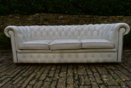 A three seater Chesterfield sofa in deep buttoned and studded leather upholstery. H.70 W.217 D.80cm