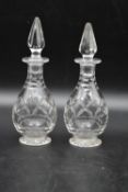 A pair of vintage crystal cut glass vinegar and oil bottles with tops. H.20cm (2)