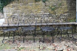 A set of four wrought metal garden armchairs with pierced seats. H.75 W.56 D.46cm