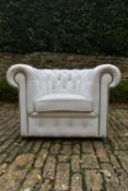 A Chesterfield armchair in deep buttoned and studded leather upholstery. H.70 W.103 D.80cm