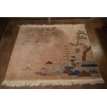 A Chinese rug with lake scape decoration on a blush ground. L.180 W.194cm